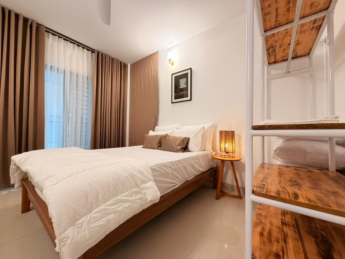 Guest bedroom Bedroom with linen bedding and timber shelving