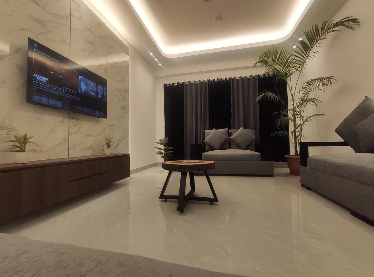 Living room, full length Long living room with sofas and media wall