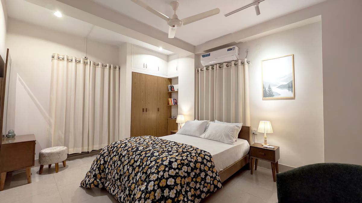 Main bedroom Bedroom with patterned bedding and warm lamps