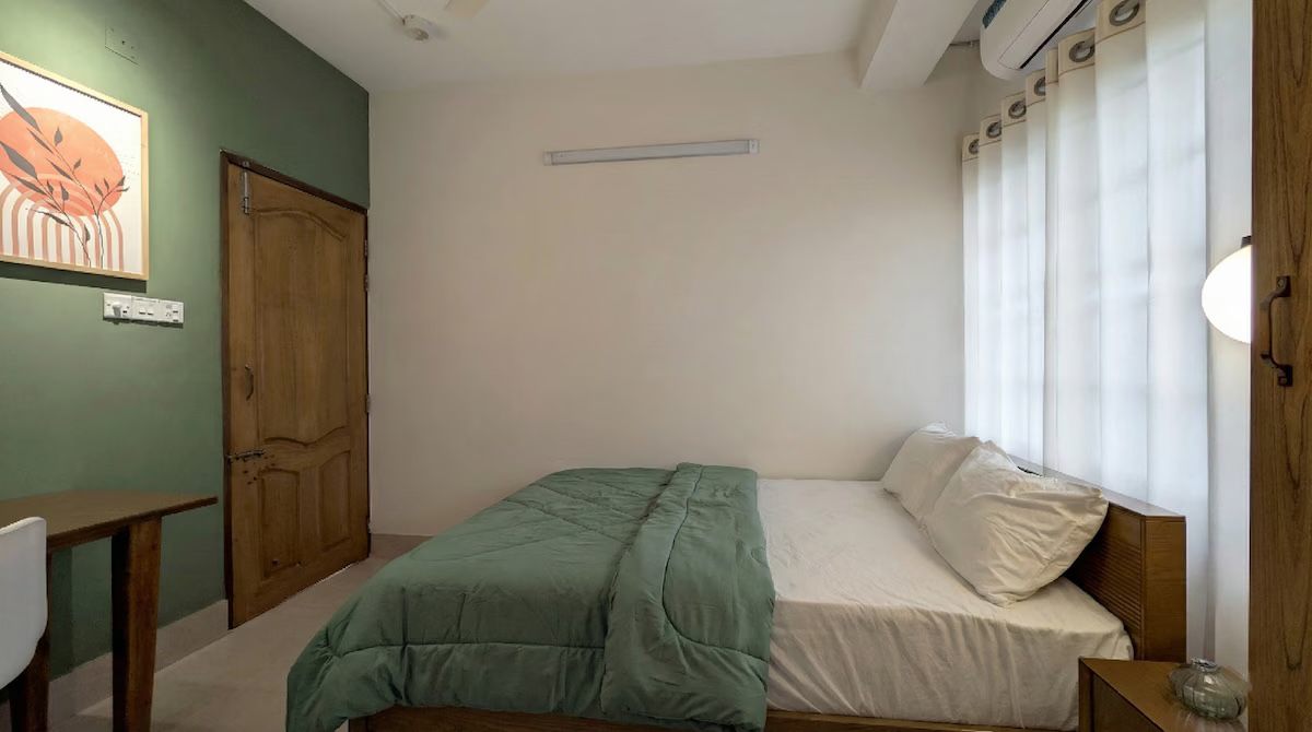 Guest bedroom Bedroom with sage wall and green bedding