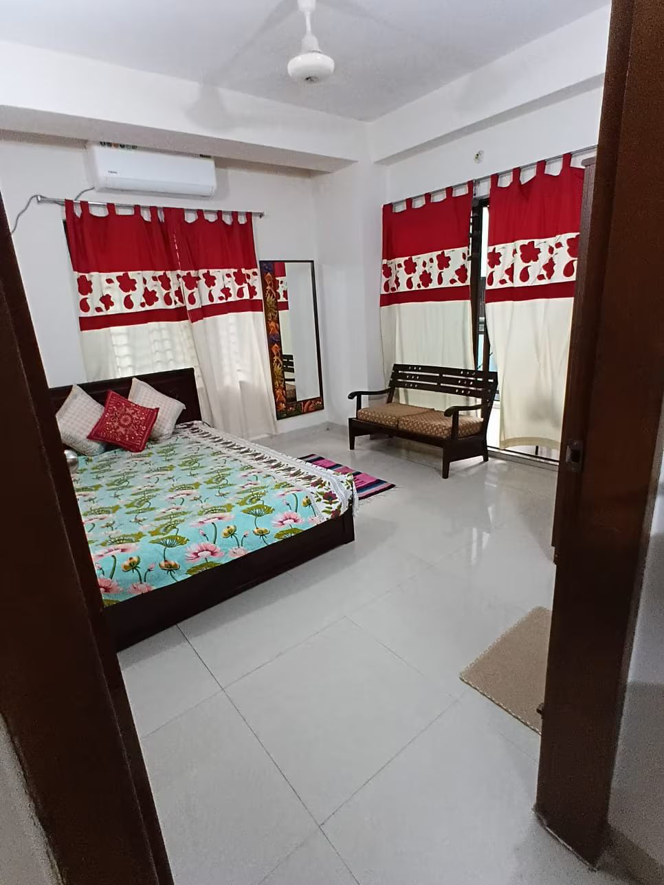 Second bedroom Second bedroom with patterned bedding and printed curtains