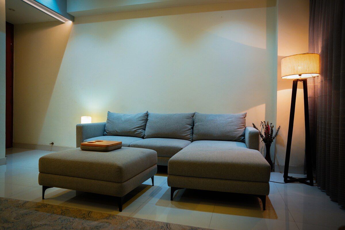 Living room Grey sofa and ottoman with floor lamp