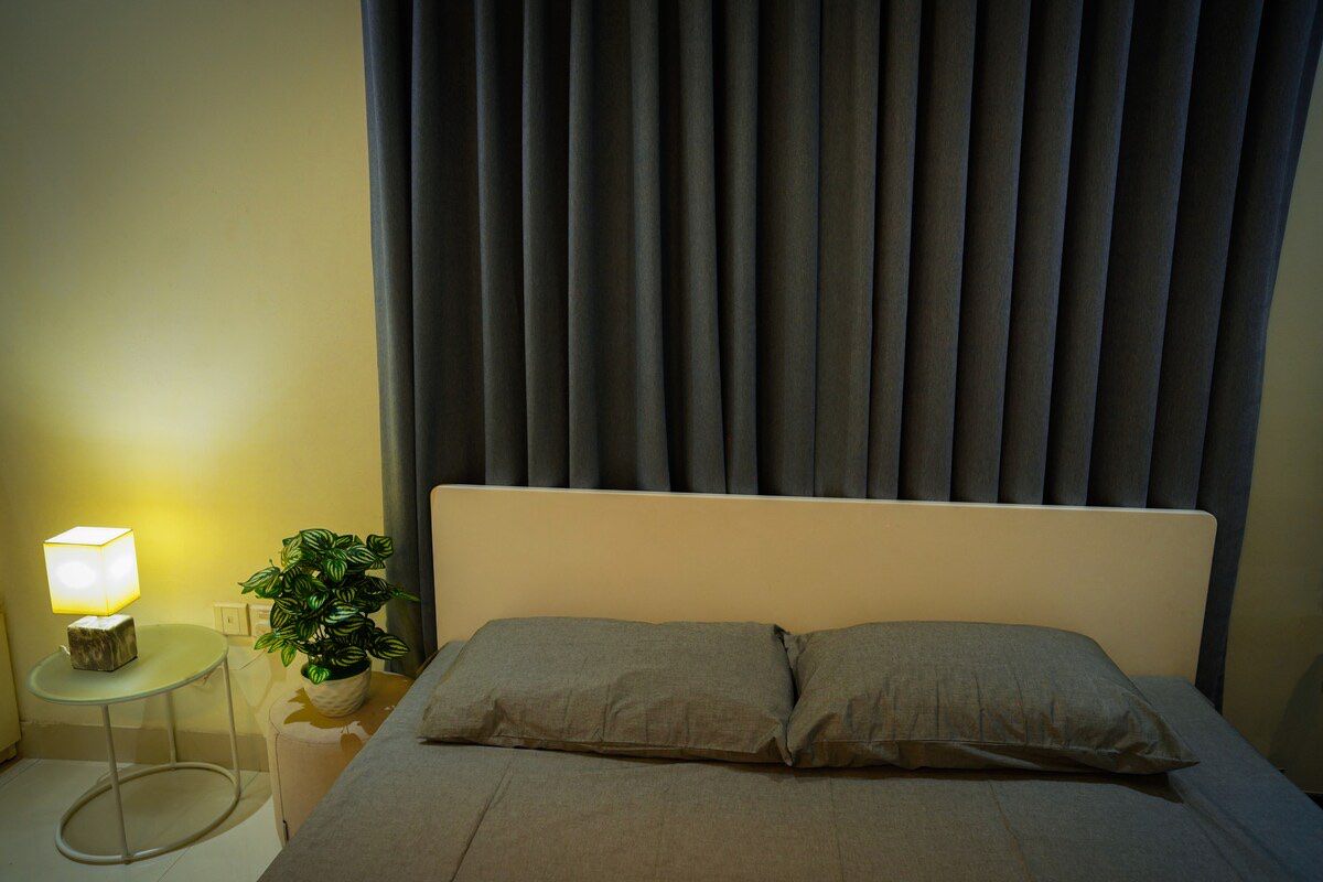 Bedroom Bedroom with upholstered headboard and lamp
