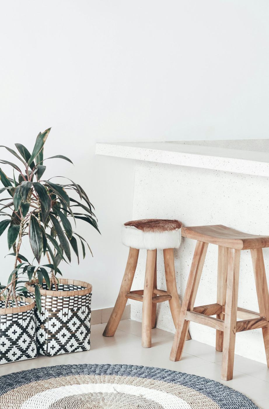 Woven jute rug with wooden stools
